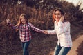 Happy mother and daughter on the walk on summer field. Family spending vacation outdoor Royalty Free Stock Photo