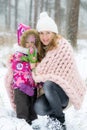 Happy Mother and Daughter Walking in Snowy Forest, Pastel Pink Merino Wool Giant Blanket, Cold Weather Royalty Free Stock Photo