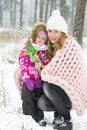 Happy Mother and Daughter Walking in Snowy Forest, Pastel Pink Merino Wool Giant Blanket, Cold Weather Royalty Free Stock Photo