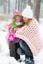 Happy Mother and Daughter Walking in Snowy Forest, Pastel Pink Merino Wool Giant Blanket, Cold Weather Royalty Free Stock Photo