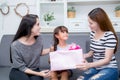 Happy of mother and daughter woman asian and aunt with gift with pink ribbon and daughter kissing mother