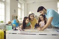 Happy mother with daughters listening father talking about vacation trip