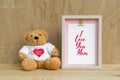 Happy mother day design concept - Mock up photo frame with I you you mom text and lovely bear on vintage wooden background for