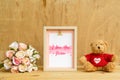 Happy mother day design concept - Mock up photo frame with I you you mom text, rose bouquet lovely bear and on vintage wooden