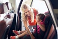 Happy mother fastening child with car seat belt Royalty Free Stock Photo