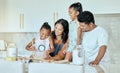 Happy, mother and father baking with children for family bonding, learning and teaching in the kitchen at home. Mama Royalty Free Stock Photo