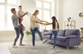 Happy mother, father and children playing games, dancing and having fun together Royalty Free Stock Photo