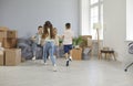 Happy mother, father and children playing and having fun in their new house on moving day Royalty Free Stock Photo