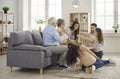 Happy mother, father, grandmother, grandfather and children playing board game at home Royalty Free Stock Photo