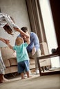 Happy mother and father at home learns to walk their child boy t Royalty Free Stock Photo