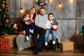 Happy mother, father and kids near Christmas tree. Happy Holidays Royalty Free Stock Photo