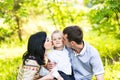 Happy mother and father kissing his little son in park Royalty Free Stock Photo