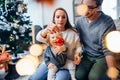 Mother, father and baby holding bauble Royalty Free Stock Photo