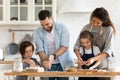 Happy mother and father with two kids baking together Royalty Free Stock Photo