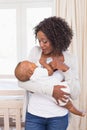 Happy mother feeding her baby boy his bottle Royalty Free Stock Photo