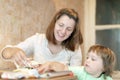 Happy mother with girl foiling fish Royalty Free Stock Photo