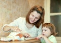 Happy mother with girl foiling salmon