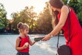 Happy mother giving daughter books for lessons at school. Little pupil ready for education Royalty Free Stock Photo