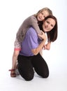 Happy mother giving daughter fun piggy back ride Royalty Free Stock Photo