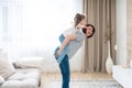 Happy mother giving joyful piggyback ride to her daughter, having fun at home, single mother happy family concept Royalty Free Stock Photo