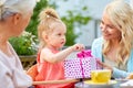 Happy mother giving present to daughter at cafe Royalty Free Stock Photo