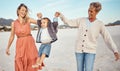 Happy, mother and grandmother holding hands with child at the beach for fun family time together in the outdoors. Mama Royalty Free Stock Photo