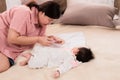 Happy mother hand holding clipper cutting newborn baby nails on tiny fingers while adorable infant sleeping, close-up keep clean Royalty Free Stock Photo