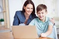 Happy mother helping his son to do homework Royalty Free Stock Photo