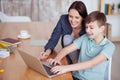 Happy mother helping his son to do homework Royalty Free Stock Photo