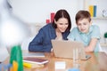 Happy mother helping his son to do homework Royalty Free Stock Photo