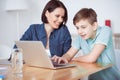 Happy mother helping his son to do homework Royalty Free Stock Photo