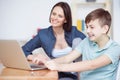 Happy mother helping his son to do homework Royalty Free Stock Photo