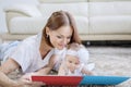 Happy mother and her baby girl reading a book Royalty Free Stock Photo