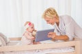 Happy mother with her baby girl using digital tablet Royalty Free Stock Photo