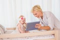 Happy mother with her baby girl using digital tablet Royalty Free Stock Photo