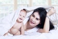 Happy mother and her baby under blanket Royalty Free Stock Photo