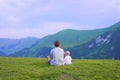 Happy mother and her child looking forward and pointing to sky. Family on trekking day in the mountains. Royalty Free Stock Photo