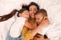 Happy mother with her children on bed, top view Royalty Free Stock Photo
