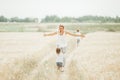 Happy mother and her children spending time together in sunny field Royalty Free Stock Photo