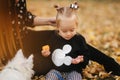 Happy mother and her daughter playing with dog in autumn park. Family, pet, domestic animal and lifestyle concept Royalty Free Stock Photo