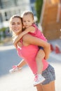 Happy mother and her daughter playing outdoors Royalty Free Stock Photo