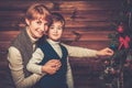 Happy mother and her lIttle boy decorating tree Royalty Free Stock Photo