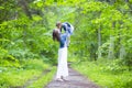 Happy Mother and Her Little Caucasian Daughter Posing with Kissing Expression Together In Green Summer Forest Royalty Free Stock Photo