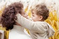 Happy mother and her little child in the park. Child playing with mother`s hair. Mother and son embracing Royalty Free Stock Photo