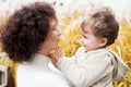 Happy mother and her little child. Smiling child playing with mother in the park. Mother and son embracing Royalty Free Stock Photo