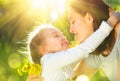 Happy mother and her little daughter outdoor. Mom and daughter enjoying nature together in green park