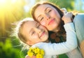 Happy mother and her little daughter outdoor. Mom and daughter enjoying nature together in green park