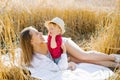 A happy mother and her little son are lying on a blanket at a picnic. Funny sweet family moments in the field outdoors Royalty Free Stock Photo