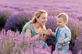 Happy mother and her little son phaving fun in a lavender field Royalty Free Stock Photo