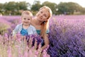 Happy mother and her little son phaving fun in a lavender field Royalty Free Stock Photo